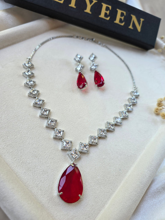 Deep red garnet teardrop necklace and earrings set with CZ halo — white gold plated bridal jewellery — Eliyeen
Close-up of deep red garnet teardrop pendant