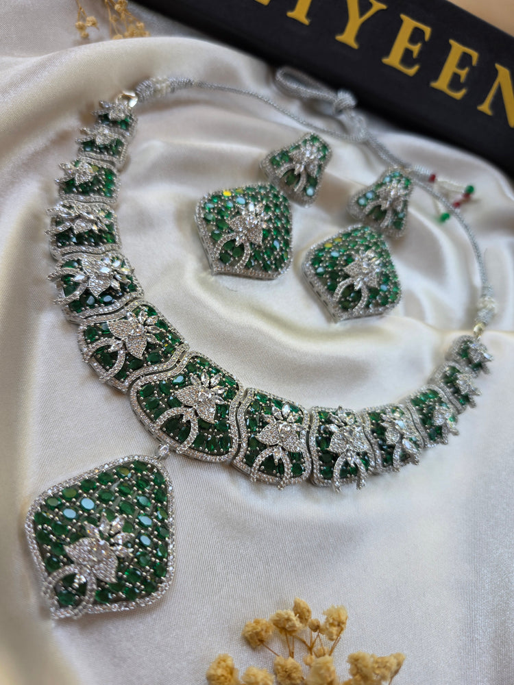 Close-up of bold emerald green statement necklace with cubic zirconia border — Eliyeen