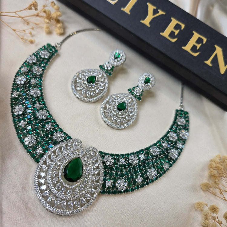 Close-up of emerald necklace with central emerald stone and cubic zirconia encrusted band — Eliyeen